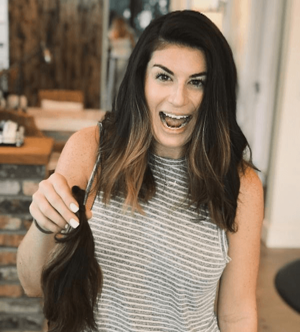 Salon worker holding lock of hair