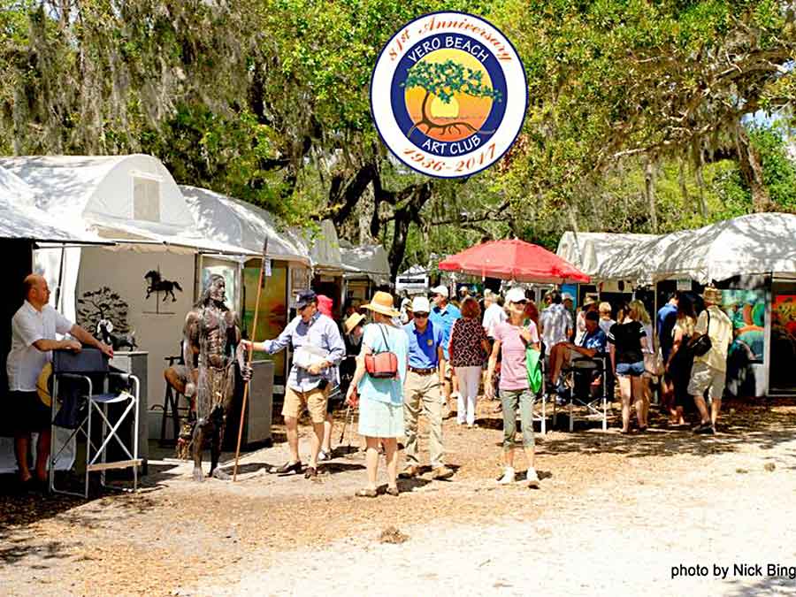People strolling between tents displaying art work at the Vero Beach Art Club Vero Beach Florida