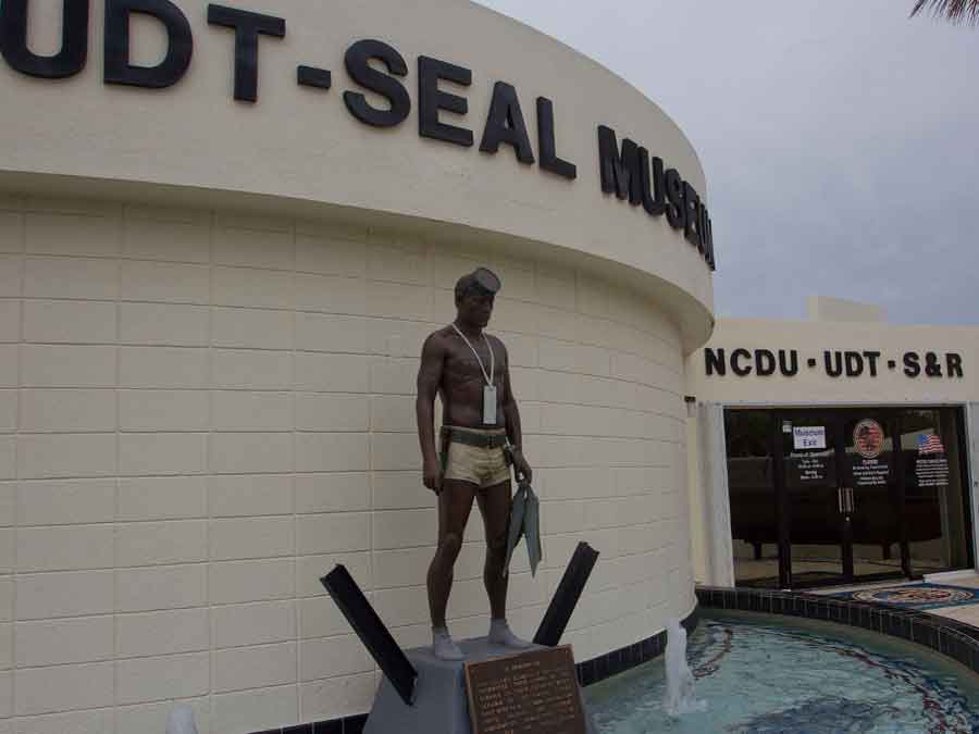 statue of a Navy Seal with mask and fins outside museum