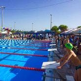 Racers getting ready to mount starting blocks for a race at North County pool