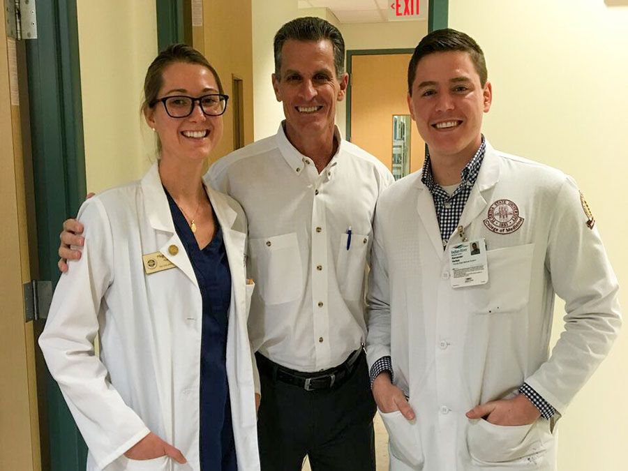 Doctor Patrick Ottuso with a male and a female medical student