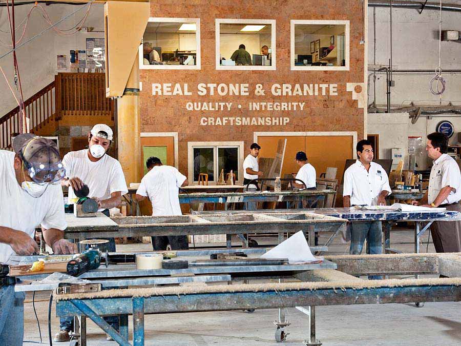 fabrication floor with men cutting granite