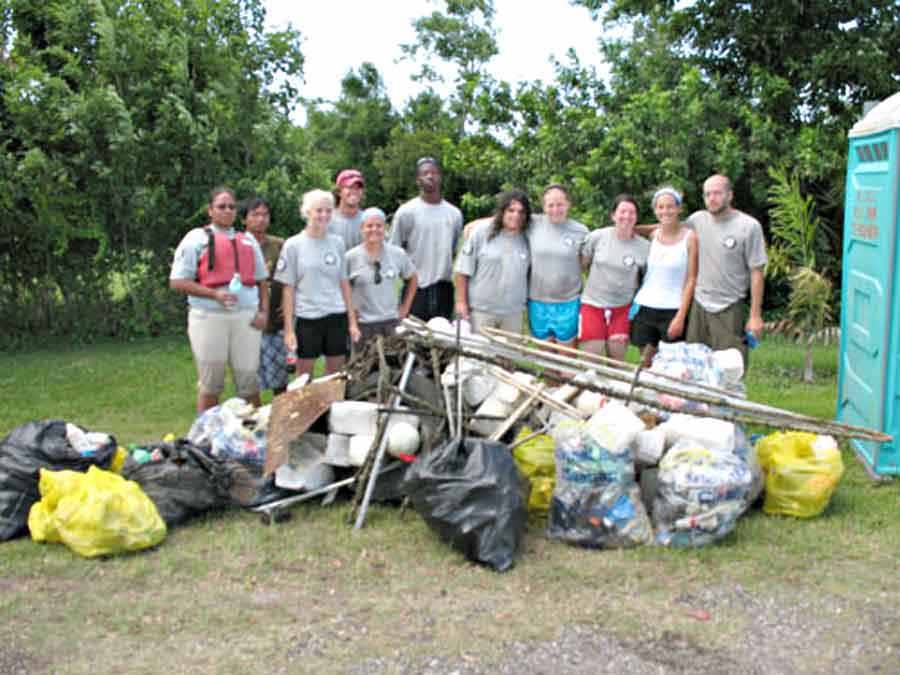 Photo of group with pile of trash collected