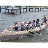 group paddling large canoe