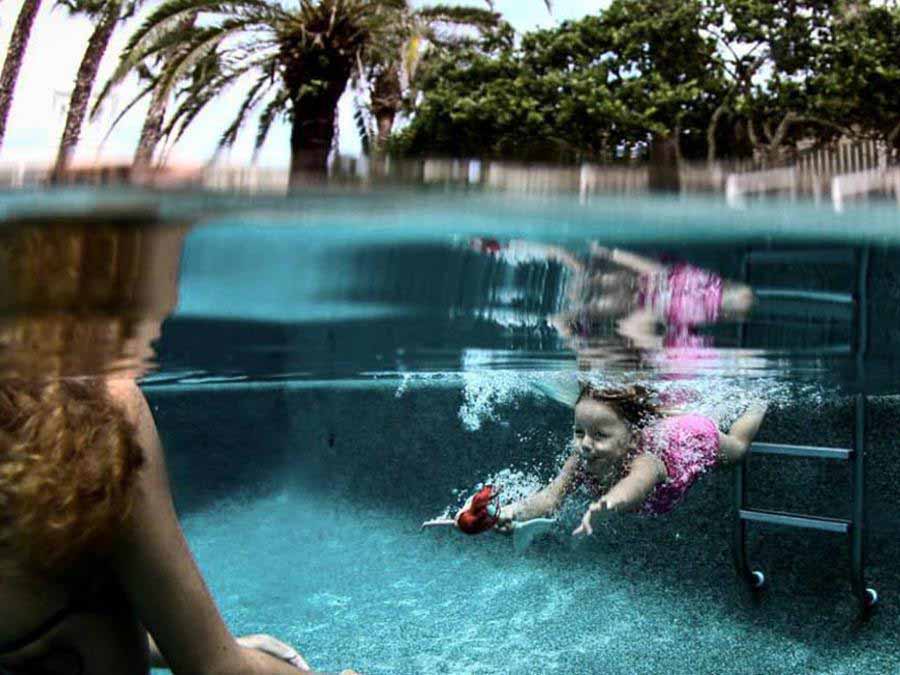 young girl swimming under water