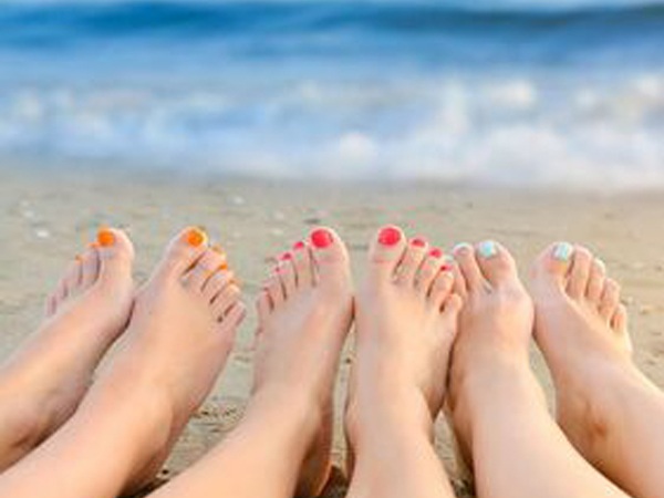 Ladies feet on the beach